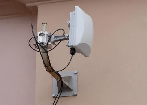 Security camera against the background of the gray wall of the building Photos