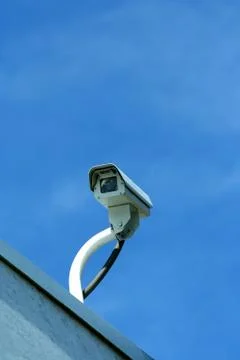 Security camera against blue sky Stock Photos