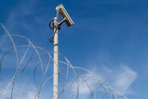 Security camera and barbed wire Stock Photos