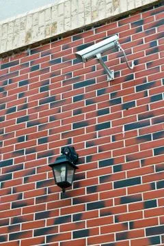 Security camera and flashlight on the wall Stock Photos