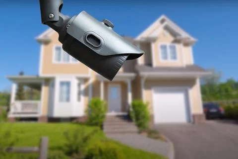 Security camera and private house on the background. Stock Photos