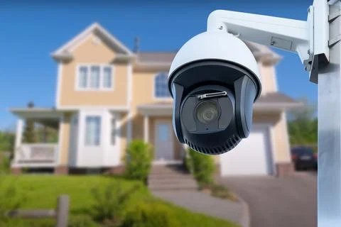 Security camera and private house on the background. Stock Photos