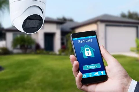 Security camera and smart home app, private house on the background. Stock Photos