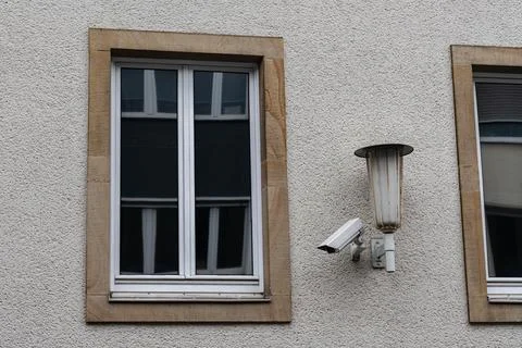 Security camera and window on a building wall Stock Photos