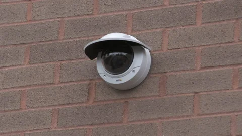 Security Camera Attached to Brick Wall 4K Stock Footage 145998353