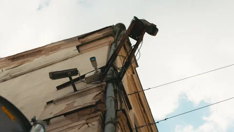 A security camera is attached to a buildings side Stock Footage 275207003