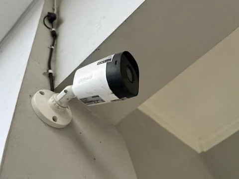 Security camera attached to the wall of a house Stock Photos