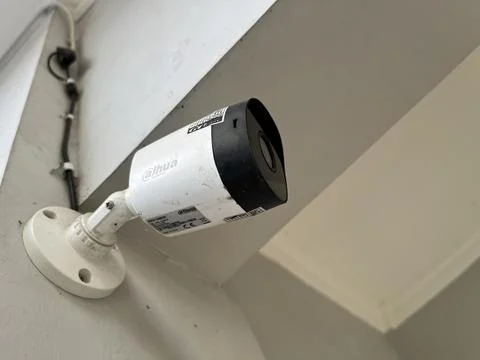 Security camera attached to the wall of a house Stock Photos