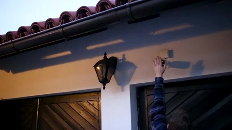 Security camera being cover by hands so camera can not  see Stock Footage 205367342