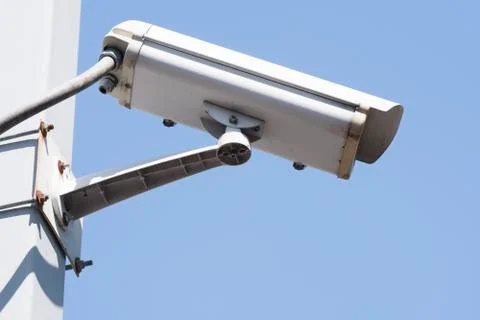 Security camera on blue sky background, property protection Stock Photos