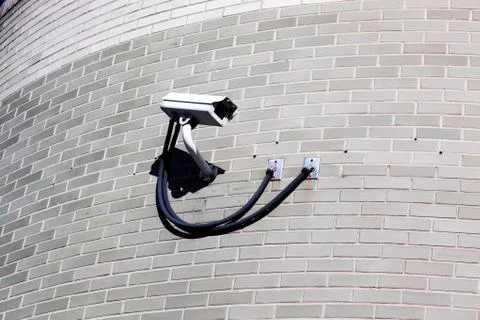 A security camera on a brick wall 写真素材