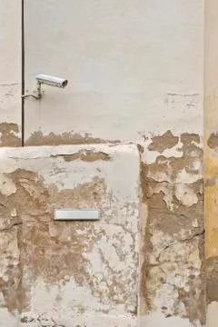 Security camera CCTV and metal plate for street name on the wall Stock Photos