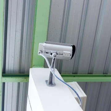 Security camera cctv under roof in factory Stock Photos