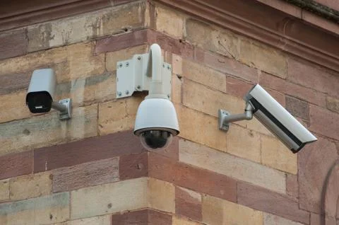 Security camera in the city on building facade Stock Photos