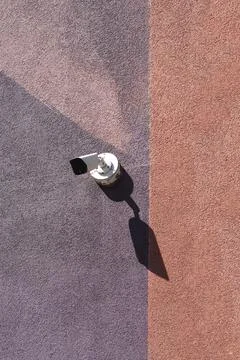Security Camera on Colorful Stucco Wall Stock-Fotos