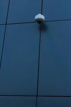 Security camera on dark modern building Stock Photos