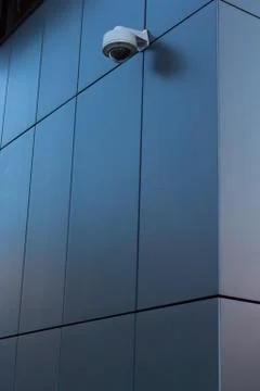 Security camera on dark modern building Stock Photos