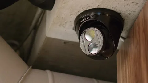 Security camera with dual lenses mounted on concrete ceiling for surveillan.. Stock-Footage 339649271