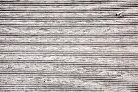 Security camera on gray brick wall Fotos de archivo