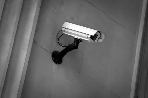 Security camera on a gray wall Stock Photos