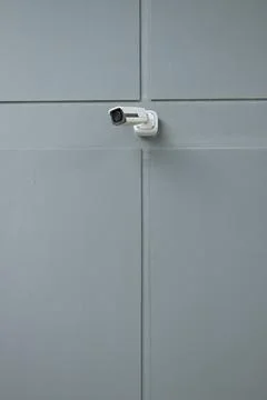 Security camera on gray wall Stock Photos