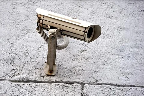 A security camera is hanging on the wall Stock Photos