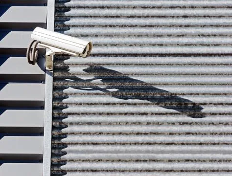 Security camera on industrial wall Stock Photos