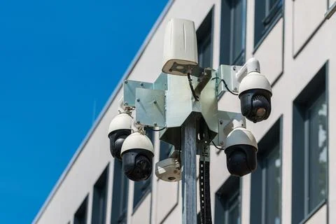 Security camera installation in urban setting on clear day Stock Photos
