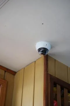 Security camera installed in building corner for safety Stock Photos