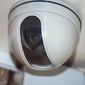 Security camera on the light ceiling in office Stock Photos