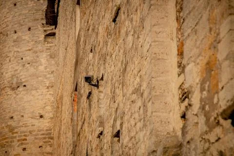 Security camera on medieval stone wall Foto stock