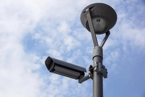 Security Camera in a Modern Building and cloud sky background Foto stock