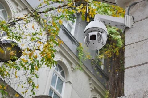 Security camera monitors streets during fall season Stock Photos