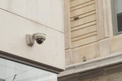 Security camera mounted on a building in a city area Stock Photos