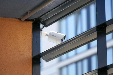 Security Camera Mounted on a Building Corner on a Bright Day in an Urban Ar.. Stock Photos