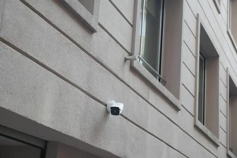 Security camera mounted on building exterior wall Stock Photos