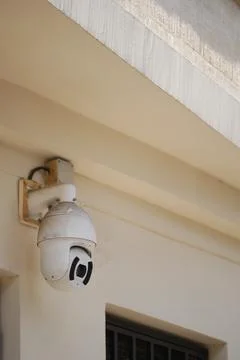Security camera mounted on building near entrance area Stock Photos