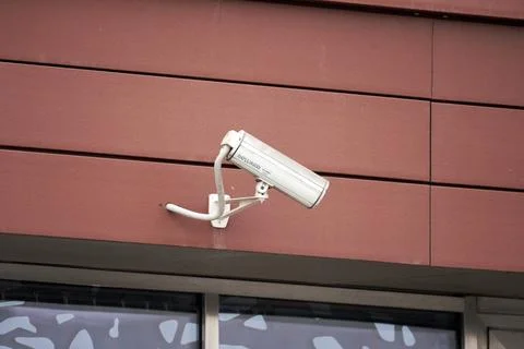A security camera is mounted on a building Stock Photos