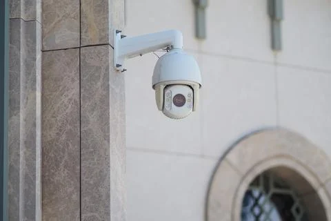 Security camera mounted on a building wall in the city 库存照片