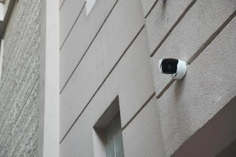 Security camera mounted on an exterior wall in an urban area Stock Photos
