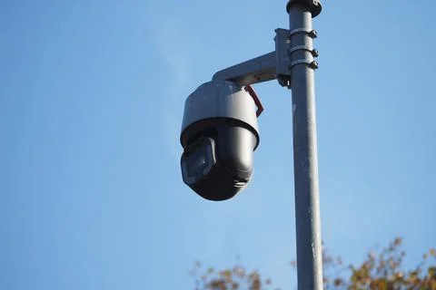 Security camera mounted on pole during daylight hours Stock Photos