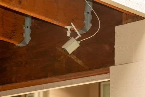 A security camera mounted in a suburban car port Stock Photos