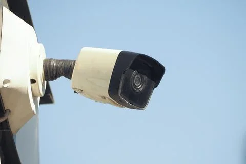 Security camera mounted on wall in clear sky 写真素材