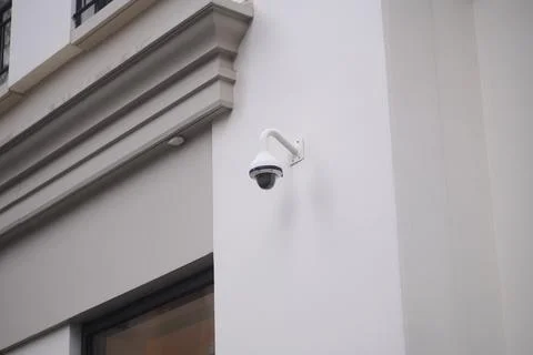 Security camera mounted on wall outside a building Stock Photos