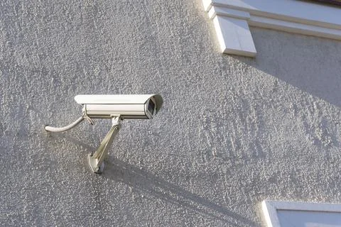 A security camera mounted on the wall of a private house Foto stock