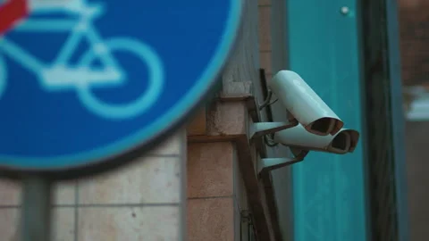 A security camera next to a sign stating No Bicycle in electric blue font Stock Footage 271156865