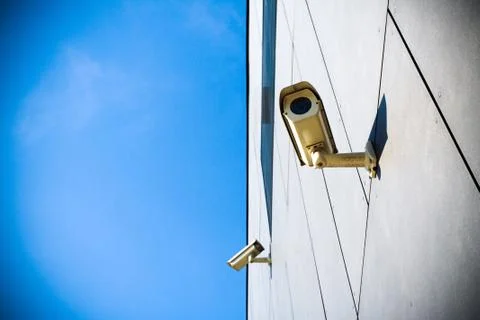 Security camera over blue sky Stock Photos