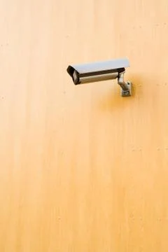 Security camera over brown background Stock Photos