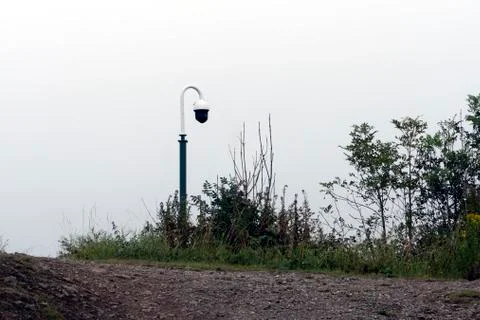 A security camera on pole in the countryside, with copy space. Stock Photos