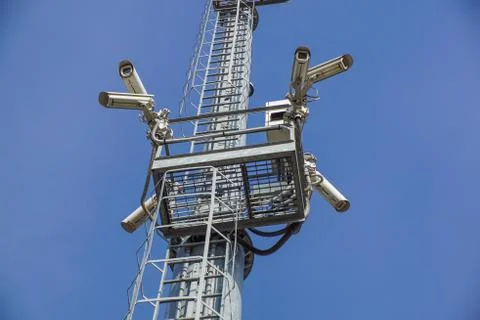 Security camera on pole high tower of CCTV system in daytime Stock Photos